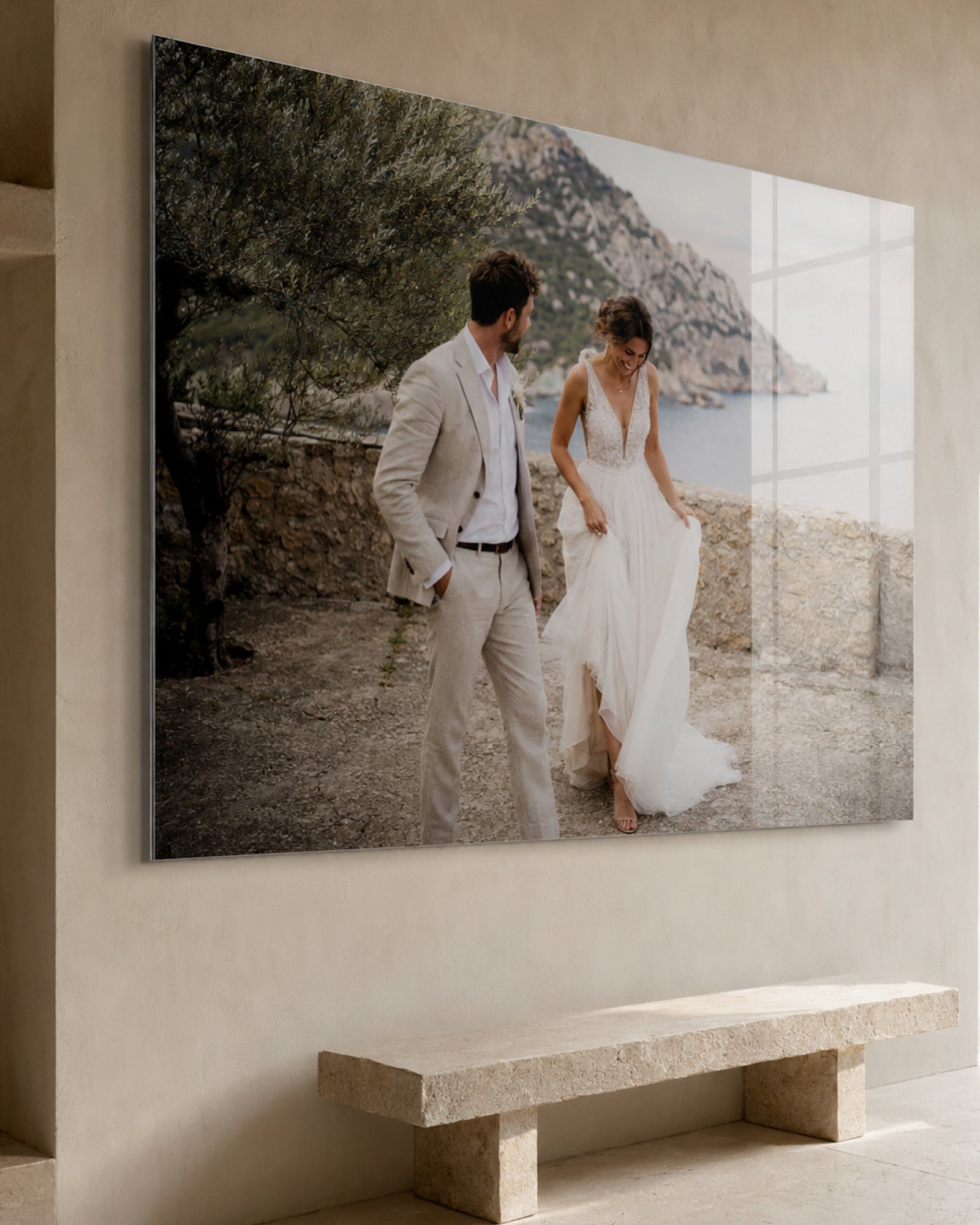 Large-scale wedding photograph behind acrylic glass in a light-filled interior